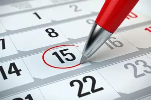 Concept of important day, reminder, organizing time and schedule - red pen marking day of the month on a calendar