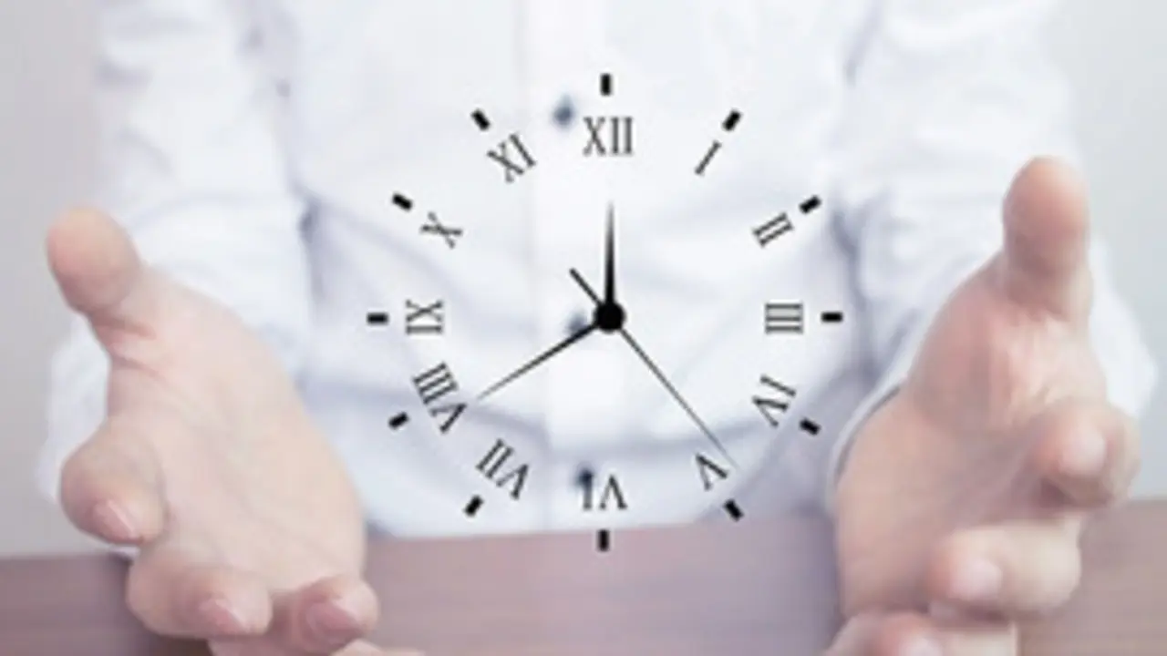 Businessman holding clock. Business time management .
