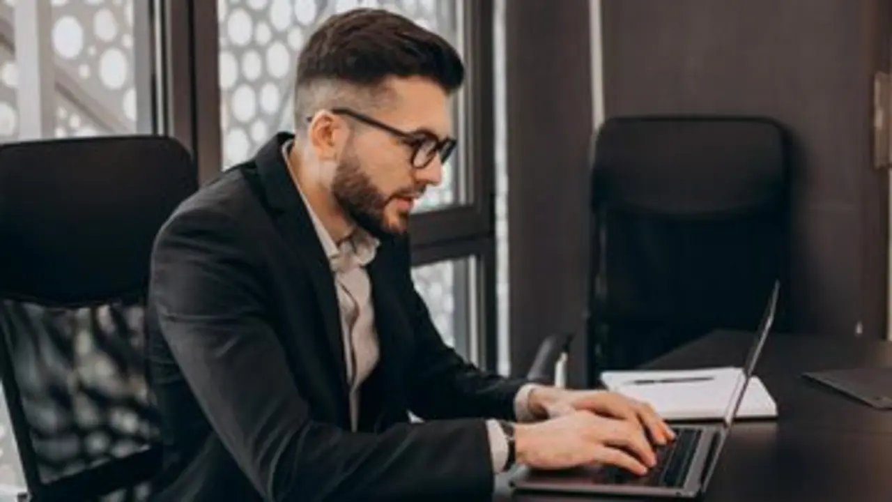 Handsome business man working on computer