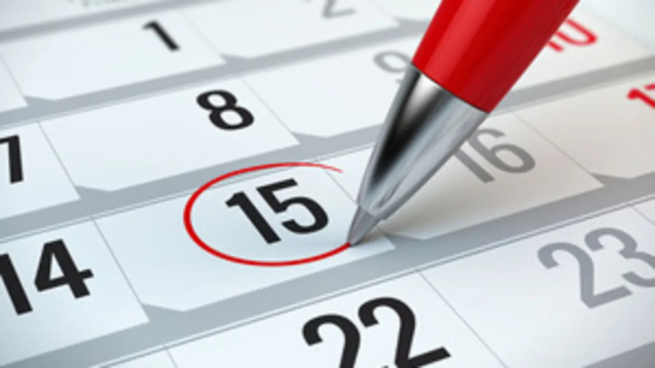 Concept of important day, reminder, organizing time and schedule - red pen marking day of the month on a calendar
